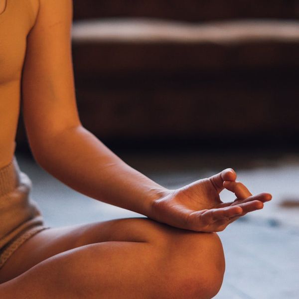Person sitting in a calm, cross-legged meditation pose.